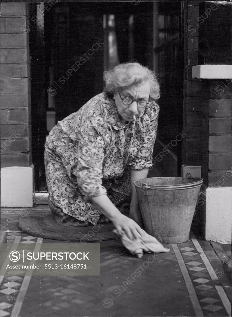 Not Proud - House Proud She's Cabinet Minister's wife, but she's no snob. Mrs. Emmanuel Shinwell wife of the Minister of Fuel and Power washing the tiled path to the front entrance of the small house in Beechcroft Road, Tooting, London, where she and her husband live. Mrs. Shinwell does all her own shopping and housework. The Shinwells celebrated their 44th wedding anniversary last week. October 18, 1946. (Photo by Mirror Features).