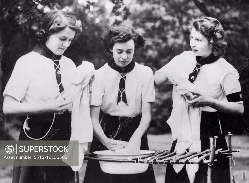 Princess With Girl Guides -- Sea Ranger Princess Elizabeth does her share of the washing-up after an outdoor meal which she helped to cook. Princess Elizabeth and Princess Margaret Rose visited a girl Guides camp. July 25, 1944.