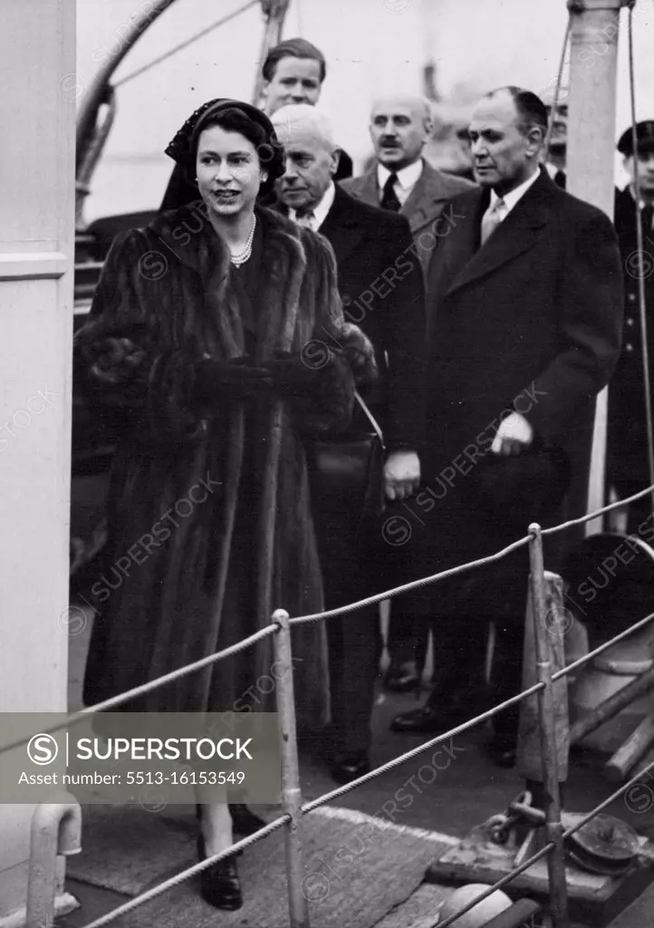 H.M. The Queen Visits The Flood Areas of Kent And Essex. The Queen coming ashore at Gravesend where she put on a fur coat to continue her tour. This afternoon H.M. the Queen paid a visit to the flood areas of Kent and Essex, accompanied by the Lord Lieutenant of Essex Sir Francis Whitmore. Apart, from three factories in Purfleet which were flooded, the Queen also visited some of the flooded homes in Purfleet, Tilbury and Gravesend. February 13, 1953. (Photo by Fox Photos).