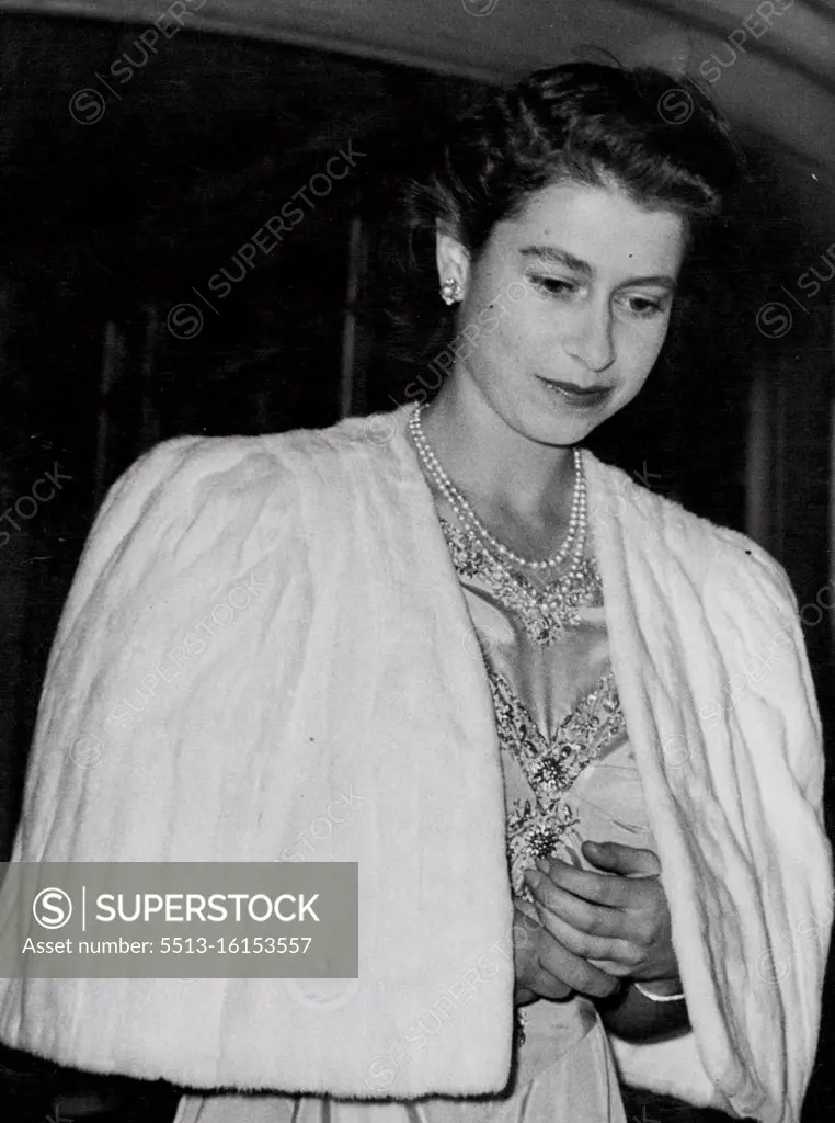 Princess Elizabeth And Lieutenant Philip Mountbatten To Wed; The Princess Attends Private Dinner Party at Dorchester Hotel. Princess Elizabeth - with folded hands - leaving the Dorchester Hotel after the dinner party. After the announcement of the engagement of Princess Elizabeth to Lieutenant Philip Mountbatten (formerly Prince Prince Philip of Greece) the Princess went to the Dorchester Hotel, in London, for a private dinner party - and later the party went to Apsley House, for dancing. July 9, 1947.