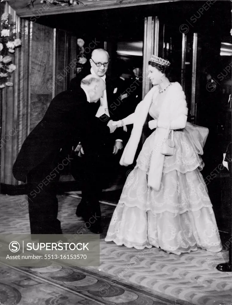 The Queen is here seen being greeted by Mr. Reginald Bromhead (Chairman and President of the Cinematographic trades benevolent fund. H.M. The Queen and The Duke of Edinburgh tonight attended the Royal Film performance at the Odeon, Leicester Square. October 26, 1953. (Photo by Paul Popper Ltd.).