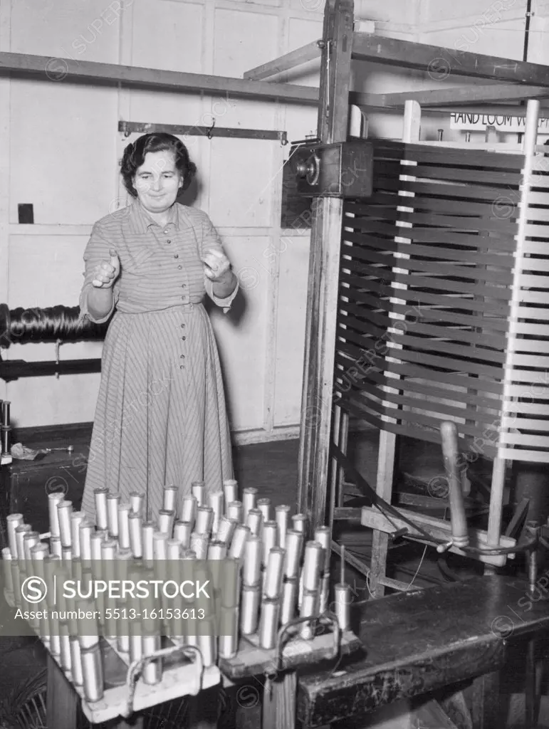 Hand Workers Have Large Share in Queen's Coronation Robe. Hand warping for silk is carried out by Mrs. Whitehead, at the Braintree mills. Cloth is formed in the loom by interlacing the warp, or longitudinal threads, with the waft, or transverse threads. Weavers began to-day (Tuesday) the half a yard a day task of making the 20 yards of velvet for the Queen's Coronation robe, at the Now Mills of Warner & Sons, Limited, at Braintree, Essex. The velvet, all silk, will be £1 inches wide. November 18, 1952. (Photo by Reuterphoto).