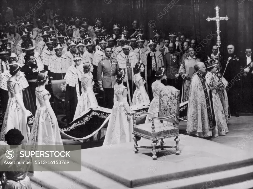 The Crowned Queen Leaves The Abbey -- The Queen, wearing the imperial state crown and carrying the sceptre with the cross and the Orb, leaves Westminster Abbey after her crowning to-day. Supporting her are the bishop of bath and well, Dr. Harold William Bradfield (right) and the bishop of Durham, Dr. Arthur Michael Ramsay. Six maids of Honour carry the Queen's train. Nearest the camera (right to left) Lady Mary Baillie-Hamilton; Lady Jane Heathcote-Drummond Willoughby; and Lady Rosemary Spencer-Churchhill. Farthest from Camera (Right to left) Lady Jane Vane-Tempest-Stewat; Lady Anne Coke; and Lady Moyra Hamilton. Peers in their Coronaets and Ermine watch the Queen's progress. June 02, 1953. (Photo by Paul Popper).