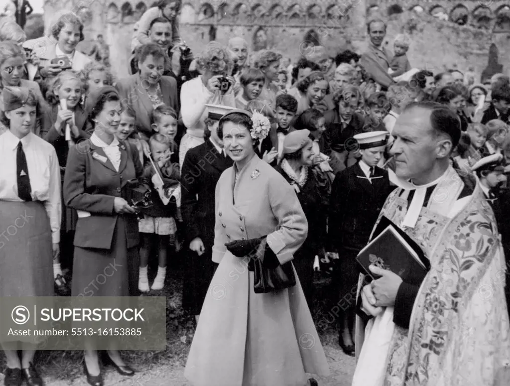 The Queen leaving St. David's cathedral wearing a hat trimmed with hydrangea. The brooch is a Scots thistle. August 7, 1955. (Photo by Daily Express). 