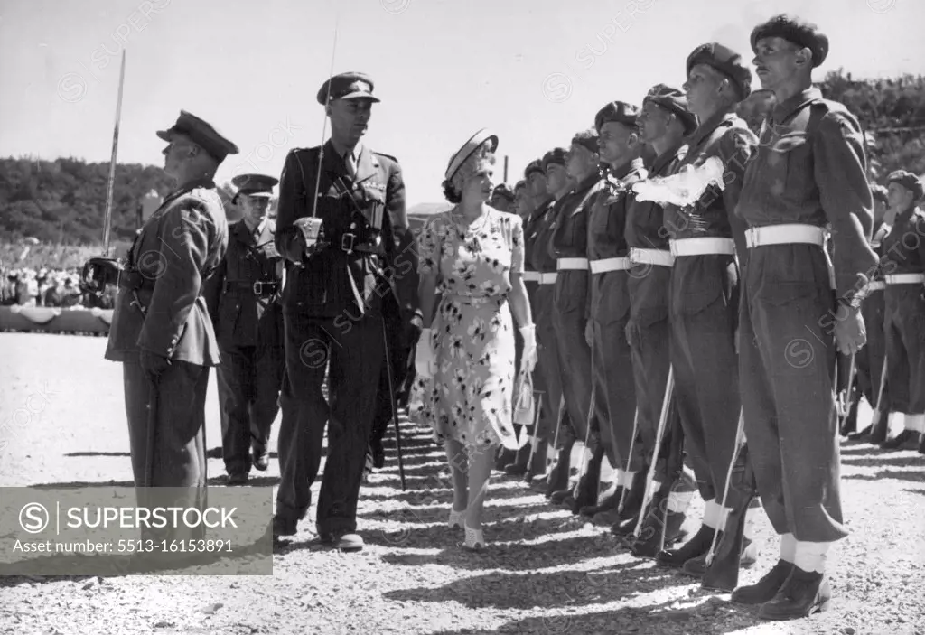 Princess Elizabeth Opens New South African Graving Dock -- Princess Elizabeth inspecting a guard of honor drawn from the Railways and Harbors Brigade. Princess Elizabeth performed her first public engagement on her own during the Royal family's tour of South Africa when she opened the new 'Princess Elizabeth' graving dock for ships up to 17,000 tons on the Buffalo River at East London by breaking a signal flag authorizing the South African Naval Forces Frigate 'Transvaal' to enter the dock. During the ceremony, the Princess received a gift of five large diamonds (estimated to be worth £4,000) presented on behalf of the Railways and Harbors administration by Mrs. F.C. Sturrock, wife of the South African Transport Minister. March 12, 1947.