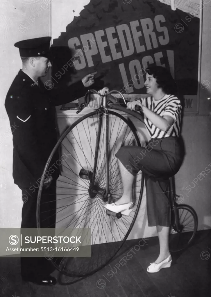 A word of warning from Police Courtesy Lecturing Staff officer, Constable Tyrrell, is heeded by Joan McMahon, at the Road Safety exhibition at Sydney Town Hall. December 05, 1948.