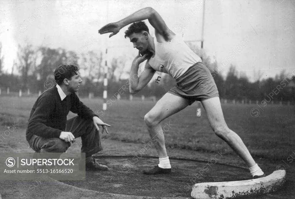 Britain's Possibles For The Next Olympic Games - John Savidge, now serving with the Royal Marines, and who specialises in the Shot and Discus, gets a few hints from Geoffrey Dyson during training at Motspur Park, London. November 11, 1949. (Photo by Sport & General Press Agency, Limited).