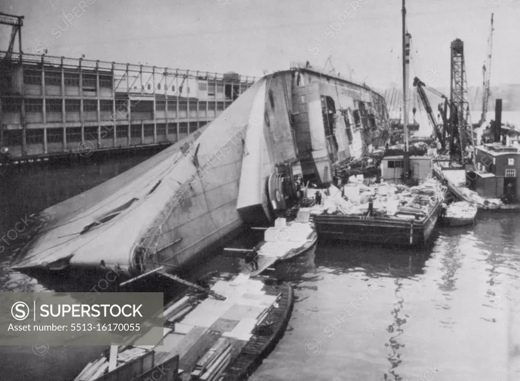 Navy To Refloat The Capsized Normandie -- Preliminary work in raising the burned and capsized liner Normandie at its pier is under way. The Navy announced today the job would take about a year. Barges and other equipment lie alongside the overturned giant in this picture made yesterday. May 21, 1942. (Photo by AP Wirephoto). More infor During World War II, Normandie was seized by U.S. authorities at New York and renamed USS Lafayette. In 1942, the liner caught fire while being converted to a troopship, capsized onto her port side and came to rest on the mud of the Hudson River at Pier 88