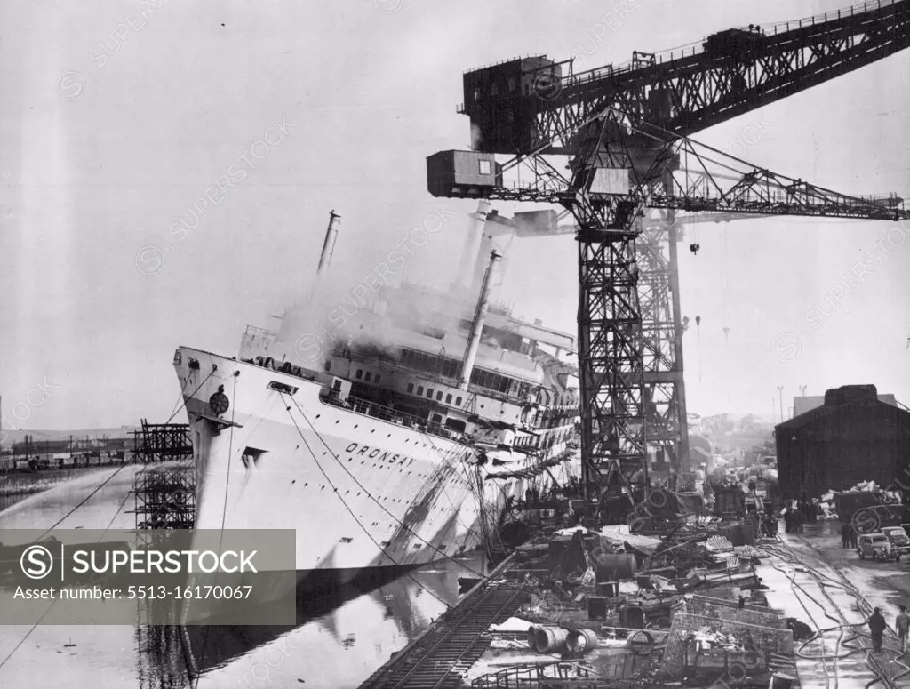 Ship Leans - Disaster Nears: The burning 28,000-ton Orient liner "Oronsay" heals over dangerously at Barrow-in-Furness while workers fight desperately to save her. A little more and she would have hit the cranes. The £3,500,000 ship, the biggest being built in Britain at present, caught fire in her dock late Saturday night October 28. Firemen fought it under control. It is not yet known how much damage has been caused. Launched last June she was due to make her maiden voyage to Australia next March. October 30. 1950.