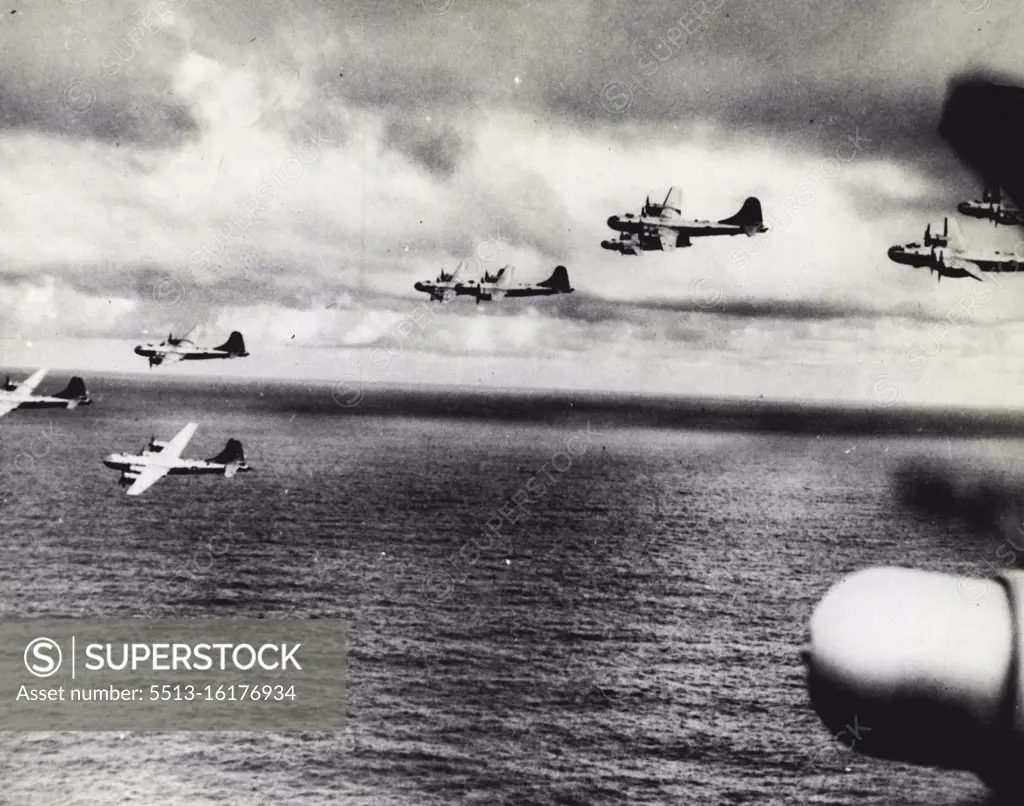 B-29'S Rehearse For Attack On Tokyo In formation, a group of B-29 Superfortresses flies over the sea near Saipan in the central Pacific Marianas, where a new base has been built for the American "sky battleships"; This was one of a series of practice flights the giant bombers made before their first attack on Tokyo on Nov. 23, 1944. After this smash at industrial targets of Japan's capital, General H. H. Arnold, commander of the U.S. Army Air Forces and commanding general of the global 20th (Superfortress) U.S. Air Force sent this congratulatory message to Brigadier General Haywood S. Hansell, commanding general of the Saipan-Based 21st BomBer Command! "You have successfully engaged the enemy in the very heart of his empire. This marks the Beginning of what I know will be a most distinguished career for the 21st Bomber Command..." December 22, 1944. (Photo by U.S. Office of War Information).