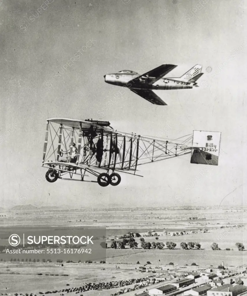 40 Years Of Progress -- What has happened to the airplane in four decades is graphically revealed hare of a an Air Force North American F-86 Sabre jet flying by a 1912 model pusher biplane. The Sabre holds the official speed record of 670 miles per hour and is powered with a turbo jet engine with a horsepower rating of 9,000 as compared to 80 horsepower and a cruising speed of 60 miles an hour for the biplane built and flown by Billy Parker. February 29, 1952. (Photo by AP Wirephoto).