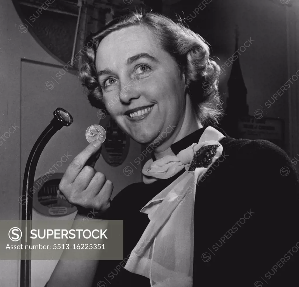 Penny-Sized Microphone -- The first tube microphone to be produced was exhibited recently at an exhibition of British Radio Components, held in London, England. During the exhibition of British Radio Components held recently in London, over one hundred manufacturers displayed new developments in every aspect of sound and vision radio engineering. Amongst the new equipment shown, by Tannoy Products Ltd. was this pencil-slim Tube Microphone, the head of which, as demonstrated by Miss Sheila Marstons is no larger than a penny. The user is therefore not masked by the head and there is no cable visible, as this is carried within the stand, which is blended, with the head into one entity. The total weight of head, stand and cable is 9 pounds. "Tannoy are responsible for the sound installations in such buildings as the House of Lords and the House of Coramons, London, and those of the United Nations Organisations in Paris and New York. May 05, 1952. (Photo by British Official Photograph)