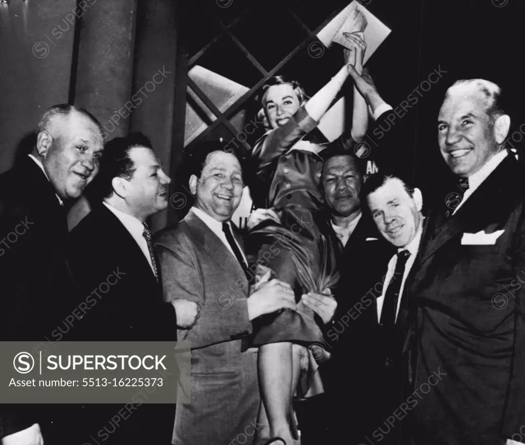 Doctor Winner of 'Operation $64,000' - Dr. Joyce Brothers, 28-year-old psychologist, is hoisted to the shoulders of some of her "staff" of boxers after winning the final and $64,000 question on the the television program of that name here tonight with her knowledge of boxing. Left to right are: Marty Sommers, A.E.F. fighter in World War I; Tony Canzeneri, Gus Lesnevich, Dr. Brothers, Bob Olin, Mickey Walker and Eddie Eagan, former Olympic boxing champion and former New York State Athletic commissioner who ***** Dr. Brothers. December 06, 1955. (Photo by AP Wirephoto).