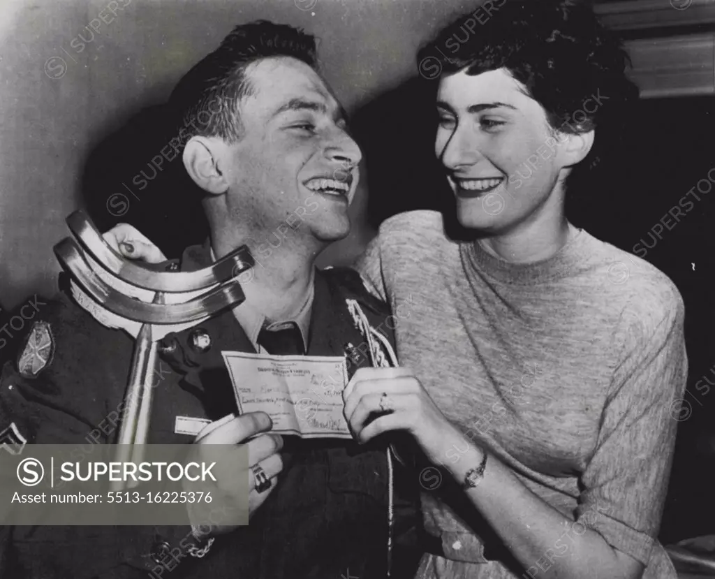 Quiz Prize Wedding Bells - Cpl. Martin Diamant, 22-year-old wounded Korean war veteran, grins happily at his bride-to-be, Rita Spolin, as they hold the $11,840 radio quiz prize check that will make their marriage possible. Diamant, a Brooklyn, N.Y., boy who suffered leg wounds during 14-month service in Korea, took the prize in the "Break The Bank" program, and immediately made plans for the upcoming wedding that hiterto had been postponed due to lack of funds. December 15, 1951. (Photo by AP Wirephoto).