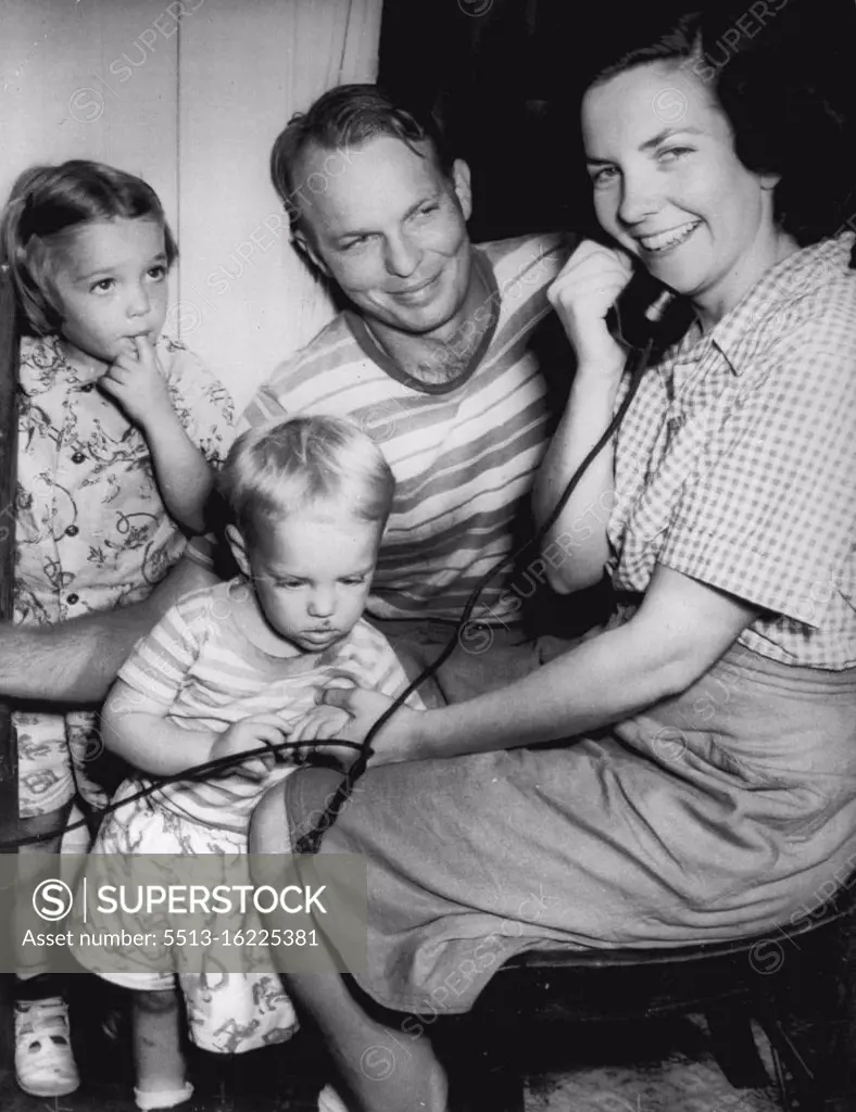 Wins $26,000 IN Prizes -- Mrs. Dorthe (cq) Pappenfort, 29-year-old housewife, happily receives congratulations after winning $26,000 in prizes on the "Stop the Music" radio giveaway show last night. Mrs. Pappenfort is shown with her husband, Carson, and their two children, Robert William, 2, and Ranne Jeanne, 4. The American Broadcasting Company said Mrs. Pappenfort correctly identified the program's mystery melody as "Buttered Peas,". August 22, 1949. (Photo by AP Wirephoto).