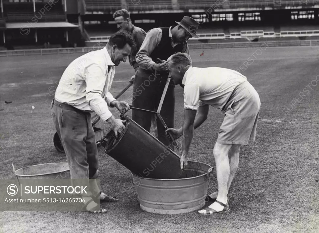 Soaking: An absorbent sponge rubber roller ***** to soak up the water on the pitch at the SCG ***** here the water is being tipped into a tub, but it ***** enough to dry up the pitch. November 17, 1946.