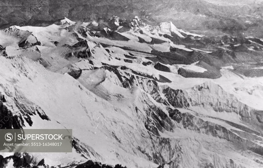 Everest. A new view of the South Col of Everest, looking north. In the extreme foreground, slightly right of centre, is Lhotse, while at the base of - the large white snow patch in the bottom left corner is the South Col. Below, and to the left of it, are the slopes leading down to the Western Cwm. Behind the snow patch is the snow-covered east face of Mt. Everest. Tibet lies in the background. March 12, 1953.