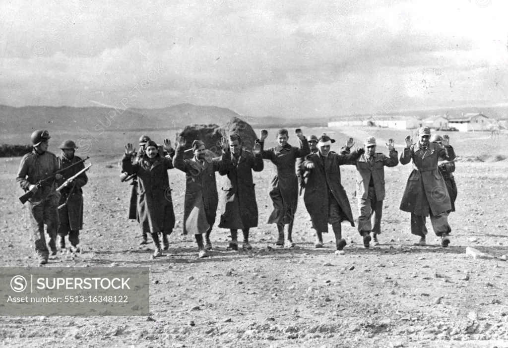 Axis Prisoners Captured in Tunisia These German and Italian prisoners were captured during the successful American counter-attack at Kasserine Pass, Tunisia. They are being marched to the rear by Allied soldiers. January 1, 1943. (Photo by U.S. Office of War Information Picture).