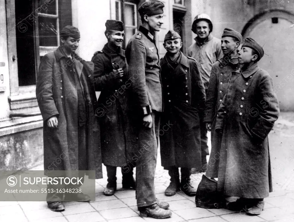 Sealing Of The Ruhr Pocket -- The U.S. 9th. Army broke through the town of Lippstadt, thus sealing the Ruhr pocket. This very small German prisoner aged 15 was smoking a cigar, to the amusement of his fellow prisoners. May 29, 1945. (Photo by Sport & General Press Agency, Limited).