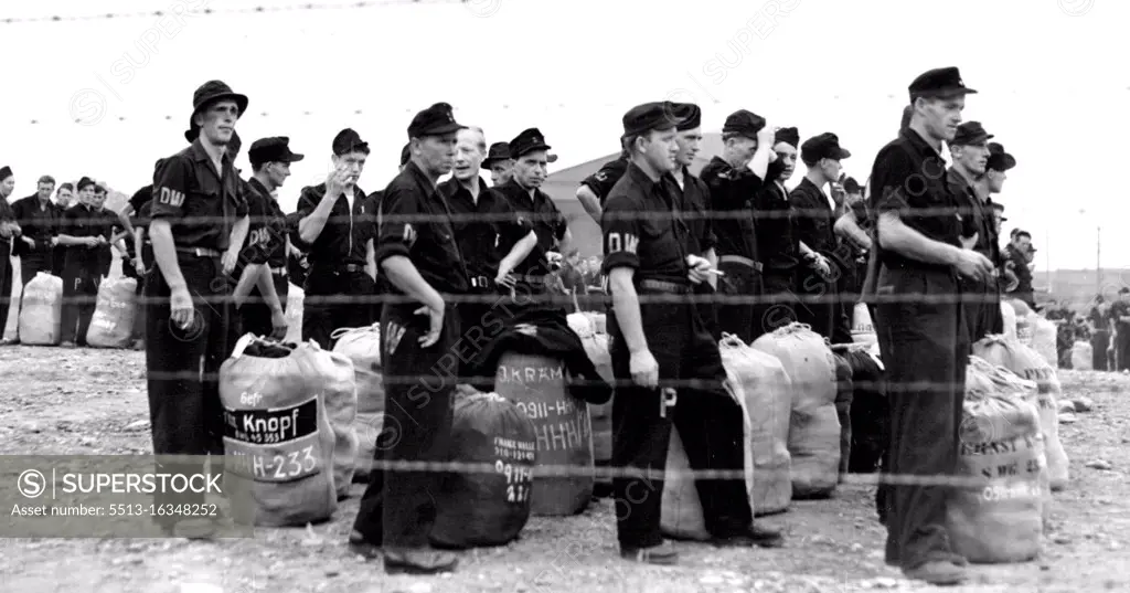 German Prisoners of War wait for start Home : German Prisoners of war make their last stand behind barbed wire in the United States as they wait at Camp Shanks, Orangeburg, N.Y., July 22, for the start of their Journey Home. This is the final group, consisting of 1,385. German Prisoners of War, to leave the U.S. leaving fewer than 300 prisoners scattered throughout the country in hospitals and special detention camps who will be returned individually. July 22, 1946. (Photo by Associated Press Photo).