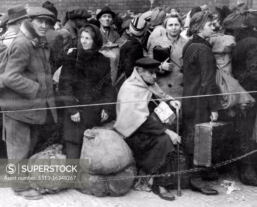 German DPS - German displaced persons, carrying Their few belongings, crowd behind a Rope and double strand of barbed wire as they wait in Berlin's Anhalter Station to ***** The German capital. October 22, 1945. (Photo by Associated Press Photo).