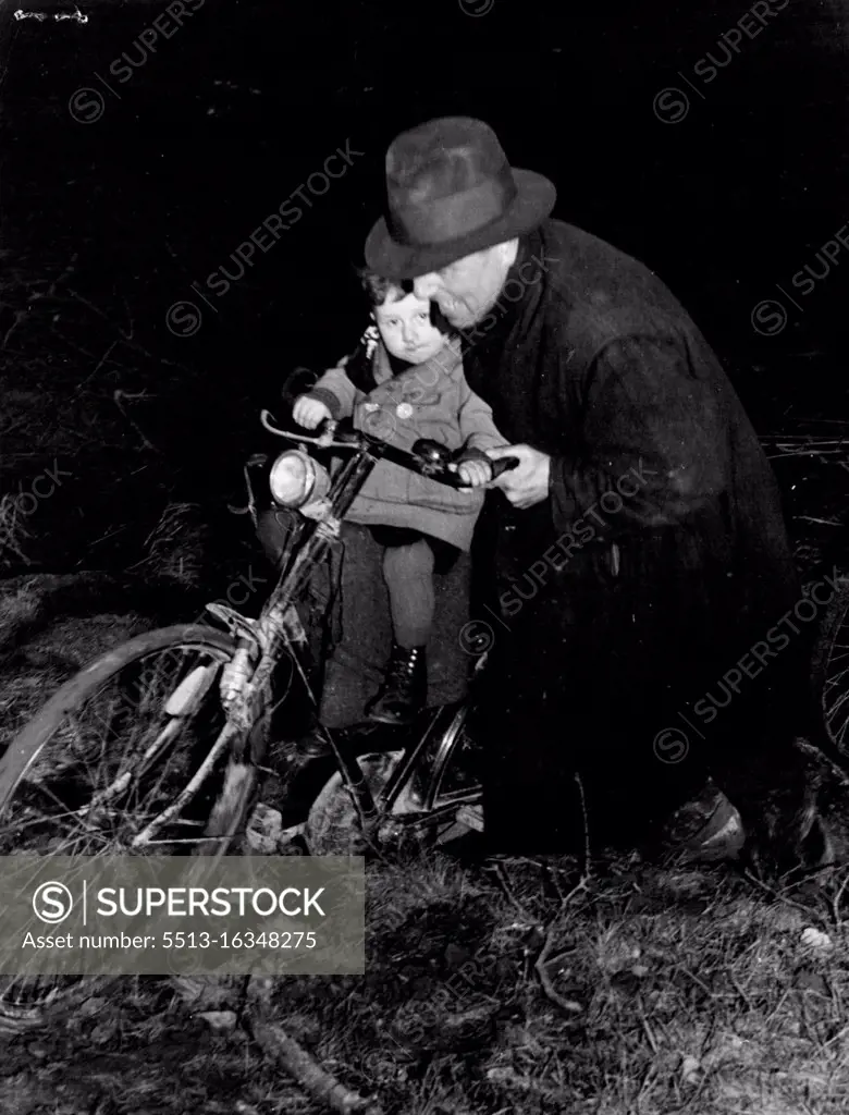 The horrors suffered by refugee victims of Hitler's lust for power now are being suffered by the German people. Here is a German pushing his little boy through the mud of a battle field to the safety of Canadian lines. April 30, 1945. (Photo by Canadian Wartime Information Board).