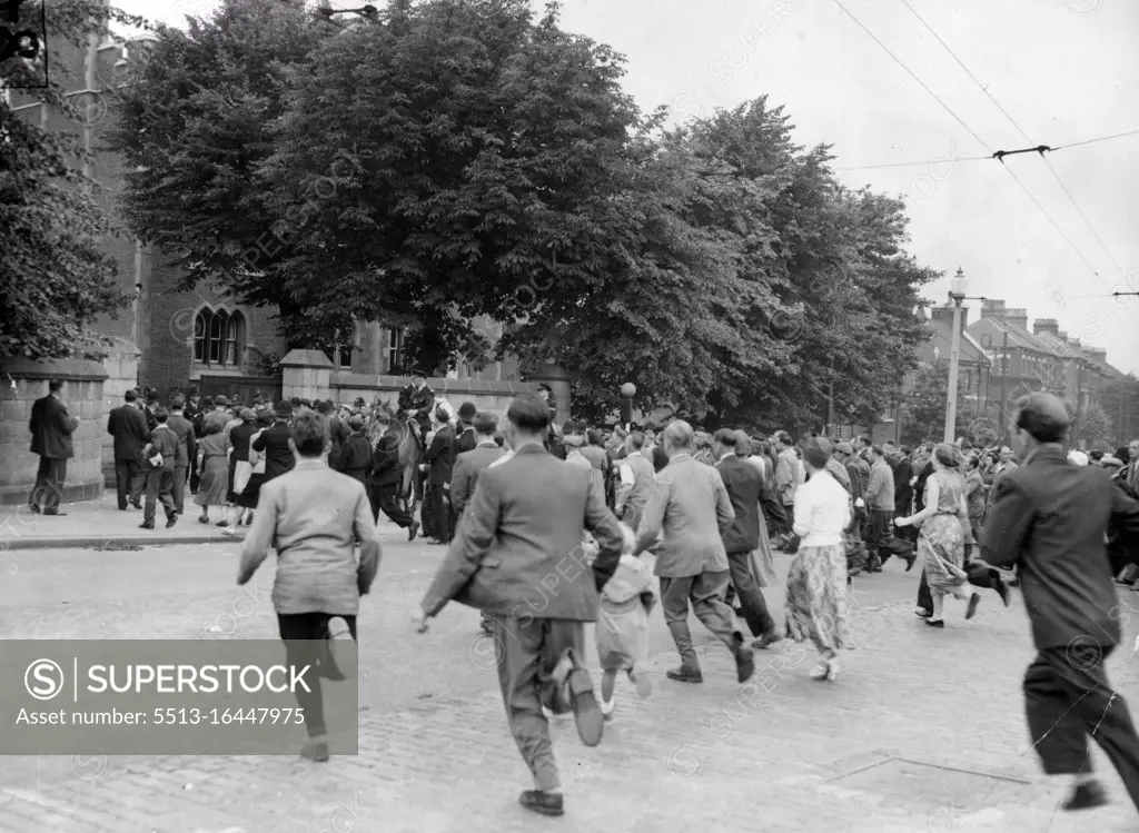 Ruth Ellis Is Hanged -- Crowds Rush across the road at Holloway Prison, London, This Morning July 13 to Read the official notice Saying Ruth Ellis had been Hanged. She was Executed for the Murder of her Lover, David Blakely, a racing motorist, and was the 14th Woman hanged in Britain This Century. Mounted Police were needed to keep the crowds in order outside the Gaol. July 21, 1955. (Photo by Associated Press Photo).