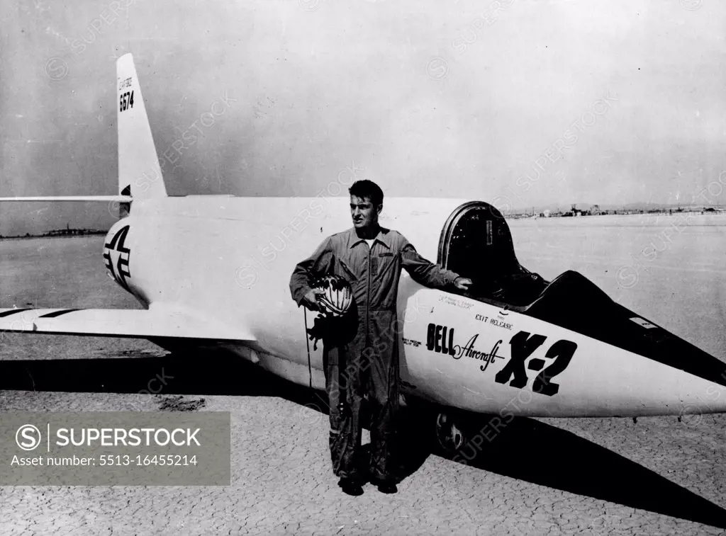 Bell's Supersonic X-2 To Probe Heat Barrier -- Lt. Col Frank K. Everest, top test pilot, who has been selected to fly the aircraft, with the Bell X-2. This Picture of the Bell X-2 is an American Rocket Powered research aircraft with swept-back wings. it is partly constructed of stainless steel to resist the tremendous heat due to air friction at extreme speeds. The X-1, an earlier model with straight wings, became the world's first supersonic aircraft in 1947, when Major Charles Yeager flew it faster than the speed of sound. August 12, 1955.