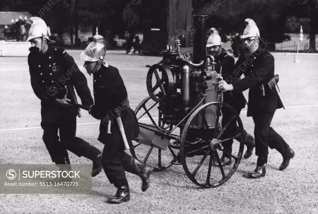 Fire-Fighters Of Old - Fire-fighting as it used to be an amusing picture during a Kent Fire Brigade display of ancient and modern fire-fighting held at Maidstone, Kent. An ancient steam-pump which had to be manhandled by the firemen to the scene of the outbreak. October 3, 1949. (Photo by Sport & General Press Agency Limited).