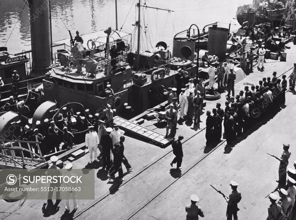 U.S. Coast Guard Cutter Sinks German U-Boat, Captures 33 Of Crew -- As U.S. Marines with fixed, bayonets stand guard, 33 officers and men of a German submarine are taken off the U.S. Coast Guard cutter Icarus, which sank their raider off the American East Coast. The cutter encountered the U-boat while on Atlantic patrol, damaged the German vessel with depth charges and finished her off with ***** when she came to the surface. The 33 survivers, including the submarine's commander, were picked up and brought to U.S. Navy base where they are shown being lined up to be marched to their guard. July 12, 1943. (Photo by U.S. Office of War Information).