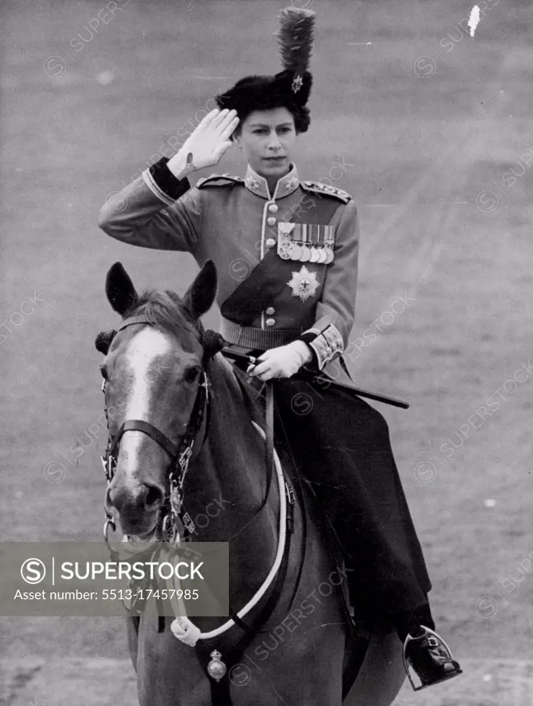 The Queen, mounted on the police horse, "Winston", takes the salute as the Guards march past the Palace to conclude the ceremony of Trooping the Colour. June 10, 1954.