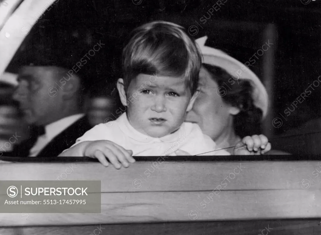 Puzzled Prince -- Arriving back home form his afternoon drive, baby Prince Charles steams puzzled at the huge crowds still gathered at Clarence House, where his mother Princess Elizabeth, a waits the birth of her second child. Thousands of people, many of them foreign tourists, have walked past the Princess home, drawn by the possibility of seeing the notice of birth posted up. August 14, 1950.