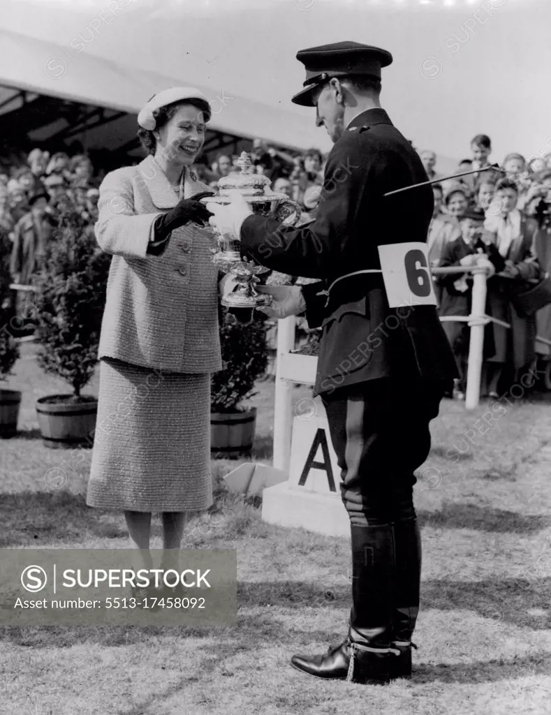 British Captain Wins Individual Championship. Major Frank Weldon, who is captain of the British team, today, (Saturday) won the Individual Championship in the European Horse Trials at Windsor Great Park. And here is The Queen presenting the individual championship trophy to Major Frank Weldon, whose home is at Warminister. May 21, 1955. (Photo by Reuterphoto).