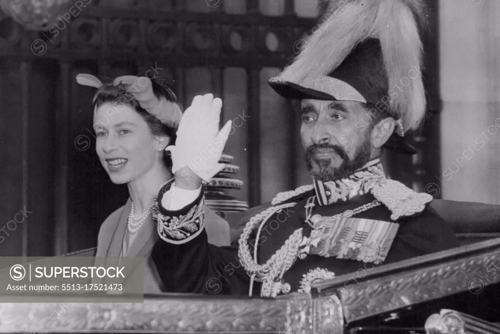 The Emperor Arrives At The Palace -- Emperor Haile Selassie waves to the crowds as he drives into the forecourt of Buckingham Palace with the Queen. The Queen, the Duke of Edinburgh and other members of the Royal Family were at Victoria Station, London, this afternoon (Thursday) to welcome the Emperor Haile Selassie of Ethiopia on his arrival for a three-day State Visit. The Emperor, who is accompanied by his son, the Duke of Harae, travelled from Malta in the Royal Navy cruiser HMS Cambia and was met at Portsmouth by the Duke of Gloucester, who accompanied him to London. During his State visit he is staying at Buckingham Palace as the guest of the Queen and will afterwards go to his English home at Bath before visiting Bristol, Oxford and several towns. October 14, 1954. (Photo by Reuterphoto).