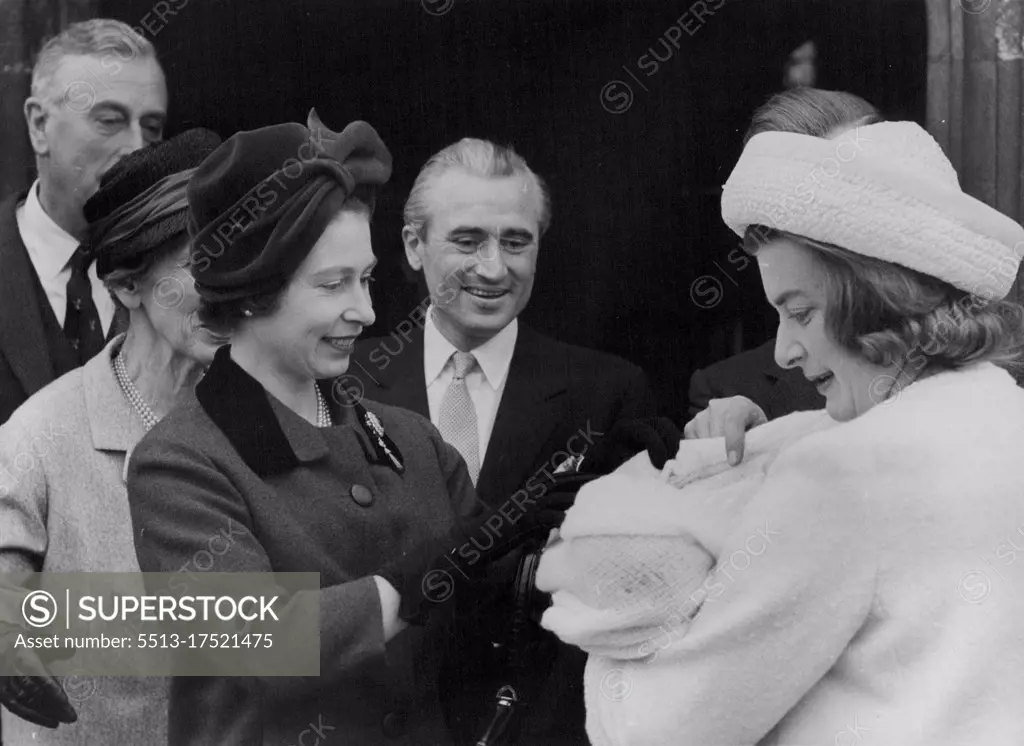 The Queen Stops The Baby Crying - The Queen looks down her godchild, Edwina, in the arms of her other, Lady Pamela Hicks. April 16, 1962. 