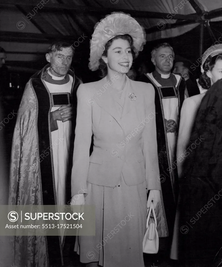 The King Unveils Nation's Tribute to "The Few" - A happy picture of H.R.H. Princess Elizabeth, arriving at Westminster Abbey to the "Battle of Britain" Ceremony to-day (Thursday). Westminster Abbey was to-day (Thursday) packed with relatives of R.A.F. and Fleet Air Arm men who dies in the Battle of Britain for the Memorial Chapel to "The Few" who, by their sacrifice, turned the tide of the war in the dark days of 1940. With the King was the Queen, Queen Marr, Princess Elizabeth, Princess Margaret, the Duke and Duchess of Gloucester, and the Duchess of Kent. Ministers of State and Service chiefs were also present, The Chapel, which includes a beautiful stained-glass window by Hugh Easton, an English walnut alter by Prof. A.E. Richardson RA, sculptured figures by A.F. ***** RA, and a silver cross and ornaments of five chapels forming the chevet of Henry VII's Chapel. Huge crowds waited in the rain to see the Royal Family, with Elizabeth, whose betrothal to Lieut. Phillip Mountbatten, AN