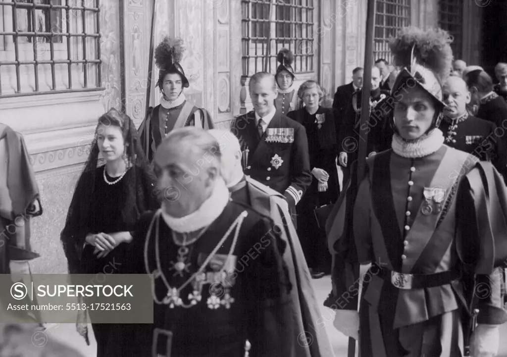 Princess leaves after Papal audience. - Princess Elizabeth is seen here passing through the Mantovani Loggia, Vatican City, followed by the Duke Edinburgh after their audience with Pope Pius X11, surrounded by Swiss Guards. and Vatican officials. Behind the Duke is Lady Palmer, Lady in waiting to the Princess. April 15, 1951. (Photo by Associated Press photo).