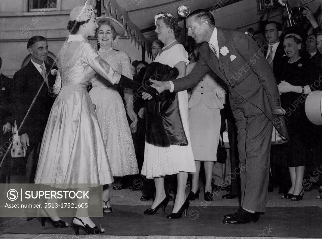 Queen Attends Friend's Wedding Reception -- The Queen is received on arrival at Hutchinson House, Stratford Palace, London, to-day (Wednesday) to attend the wedding reception of her friend, Lady Mary Baillie - Hamilton and Mr. Adrian Bailey, who were married at St. James' Spanish Place, W. Lady Mary was a maid of honour to the Queen at the Coronation. She is the daughter of the Earl and Countess of Haddington. July 21, 1954. (Photo by Reuterphoto). 