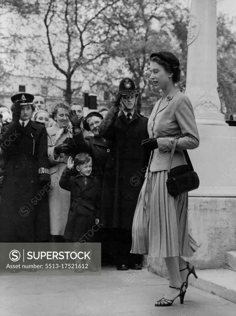 The Queen At Duchy Of Cornwall Meeting -- H.M. The Queen leaving the offices after the meeting today receives an admiring salute form the crowd and the police. H.M. The Queen, accompanied by the Duke of Edinburgh, presided at the meeting of the Princes' council of the Ducky of Cornwall at the offices of the Ducky at Buckingham gate, London, today. May 18, 1954. (Photo by Paul Popper Ltd.).