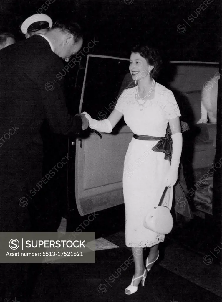 Looking delightfully summery ion this white lace dress, the Queen is welcomed to the International Horse Show at London a White City last night. The greeting handshake comes from Lord Beaufort, president of the show. The Queen, who was accompanied by the Queen Mother Margaret, went to watch the jumping in the final for the King George V Gold Challenge Cup. The Luke of Edinburgh was Joining them later. He flew back to Buckingham Palace by helicopter from Cambridge, and arrived at the Palace only a Quarter of an hour before the Queen left for the show. July 21, 1955. (Photo by Daily Mirror).