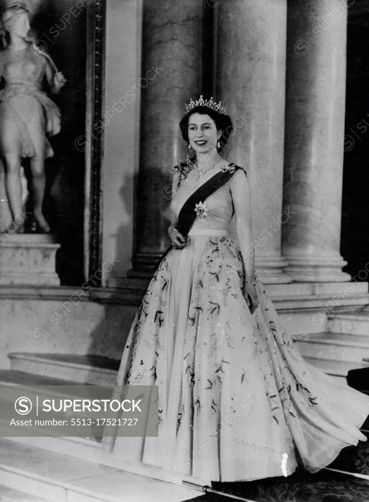 Royal Command Portrait By Baron: H.M. Queen Elizabeth II Queen Elizabeth is seen in a yellow tulle evening gown decorated with sprays of mimosa and gold paillette embroidery; she is wearing the blue Ribbon and star of the Garter. These are some details of her Majesty's Diamond shown in the Portrait: The neck lack is a wedding present from the Nizam of Hyderabad; the tiara, also a wedding present, from the late Queen Mary. The bow brooch, drop earrings, bracelet and platinum wrist watch are also set in diamonds. December 14, 1953. (Photo by Associated Press Photo).