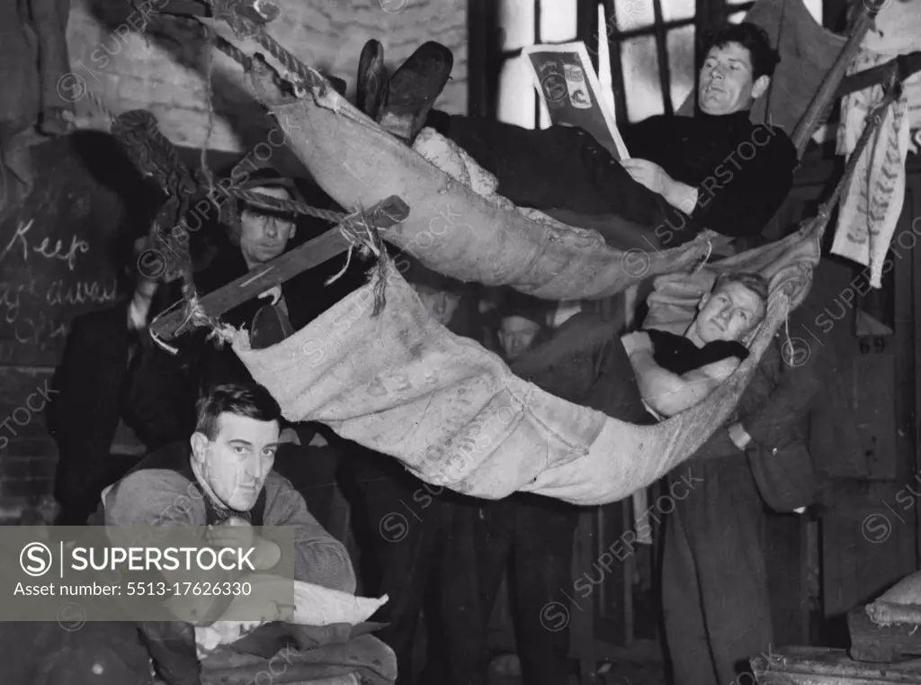 Stay-in strikers relaxing in the comfort of "home-made" hammocks at the South Melbourne gas works. August 20, 1937. 