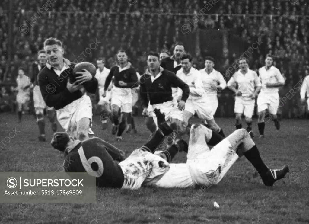 Crushing Defeat Of Scotland -- P.A. Du Toit (S.A.) gets away with the ball after P. Johnstone (S.A.) had been tackled by a Scottish Three Quarter. South Africa won a resounding victory when they defeated Scotland at Murrayfield by 44 points to nil in the first of the rugby international matches. November 25, 1951.