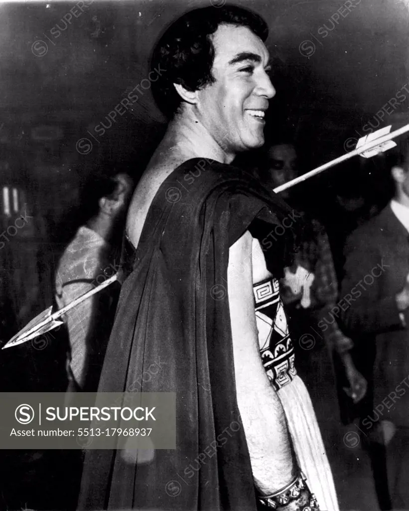 Where is the Sting -- Actor Anthony Quinn wears a broad grin as he waits to "die" on set of the film Ulysses now in production in Italy with Kirk Douglas in the title role. Quinn plays the part of Antonius. September 21, 1953. (Photo by AP Wirephoto).