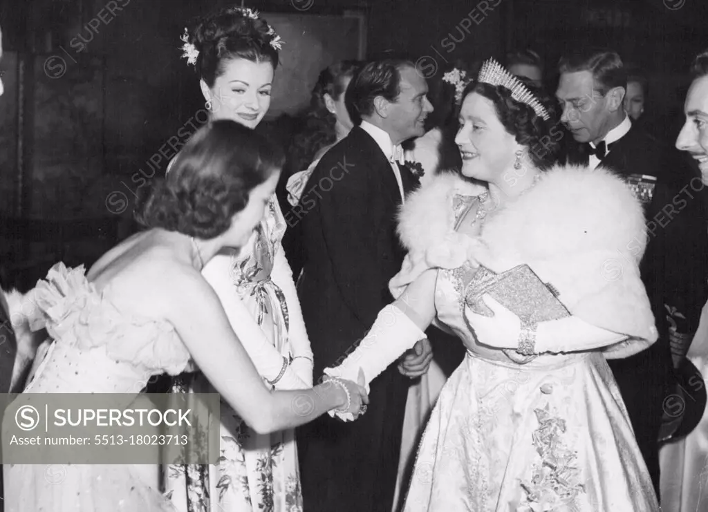 The Queen Meets Joan Bennett -- While British film star, Margaret Lockwood looks on, U.S. film star Joan Bennett curtsies to the Queen at the end of the Royal. Command film show at the Empire. Leicester-Square, London, last night, November 1.The Royal party spent twenty minutes in the lounge speaking to all the assembled stars. November 14, 1946. (Photo by Associated Press Photo)