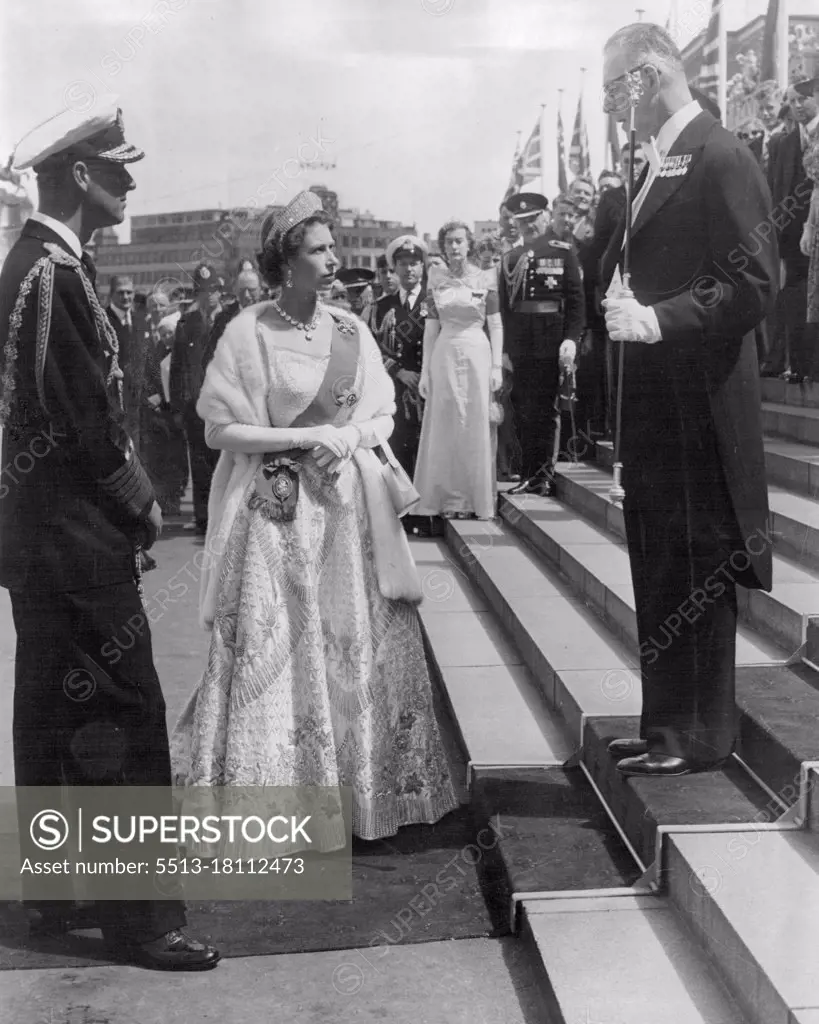 Historic scene, shows Queen Elizabeth and Duke of Edinburgh being welcomed at Parliament House, Wellington, New Zealand, when they arrived for the Opening of Parliament. Usher of the Block Rod, Major D. Brown welcomed the Royal couple. The Queen wore her magnificent Coronation gown. February 03, 1954.