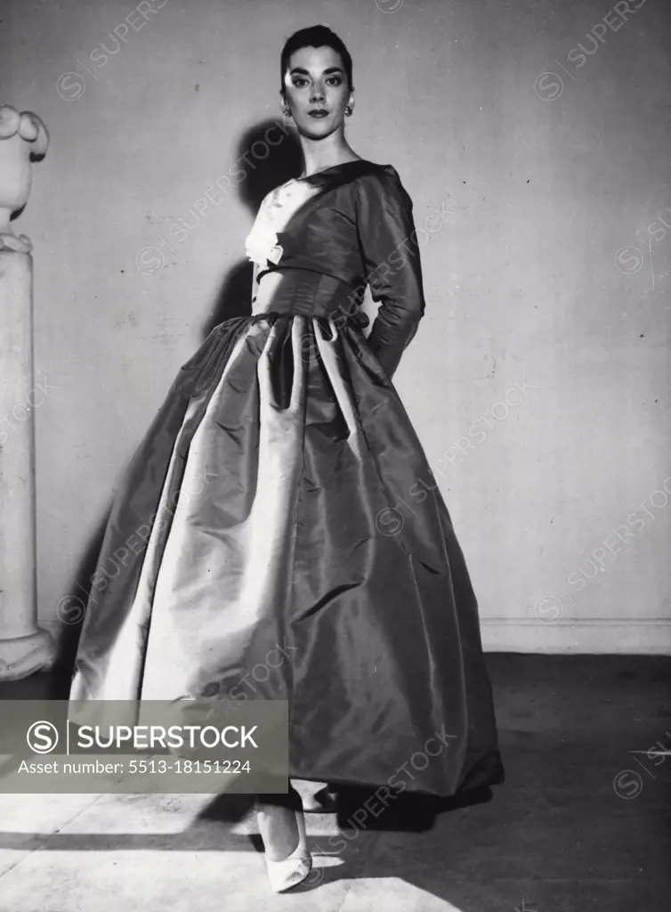 Scarlet Nights -- A red faille evening gown with a close-fitting bodice covered by a bolero, and with a barrel-shaped full skirt - form the autumn collection of the Spanish couturier Balenciaga, of Paris. August 31, 1955. (Photo by Associated Press Photo).