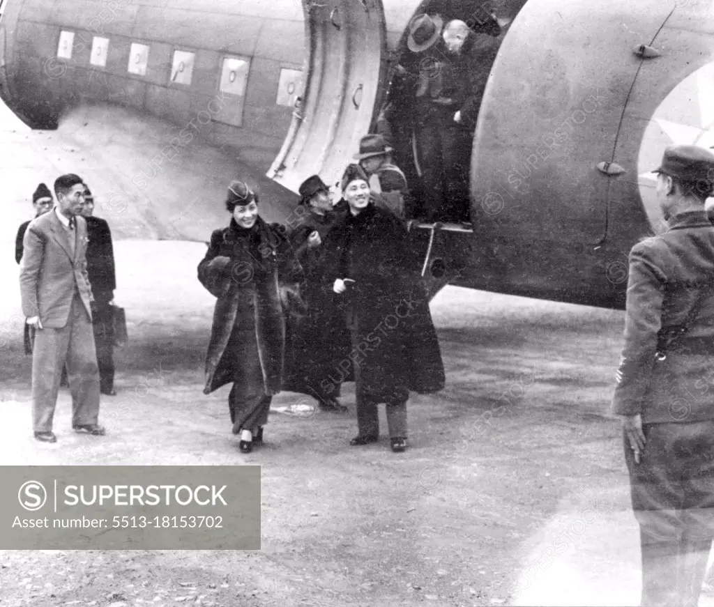 The Chiang Kai-Sheks Visit Chinese Air Base -- Generalissimo and Mme. Chiang Kai-Shek leave transport plane after their arrival at the air base of the Chinese-American composite wing, serving in the Chinese Theatre of war. The wing was formed in November, 1943, at the suggestion of Maj. Gen. Claire L. Chennault. This is an official Chinese News Service photo. May 26, 1944. (Photo by Associated Press Photo).