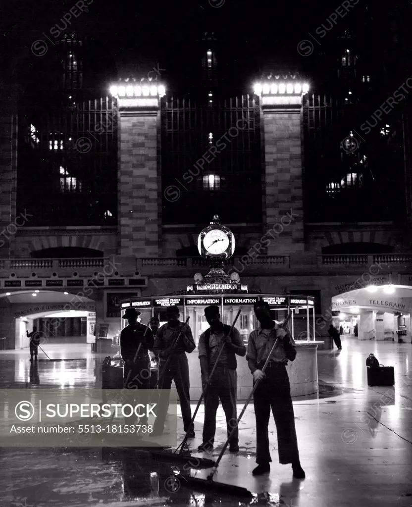 While The Big City Sleeps (Fourth Of Ten) -- A lone traveller (right) watches as Grand Central Station gets its nightly mop-up. Sixty-four porters use 4000 gallons of water to clean a total of 80,000 square feet per night. April 22, 1949. (Photo by Acme).