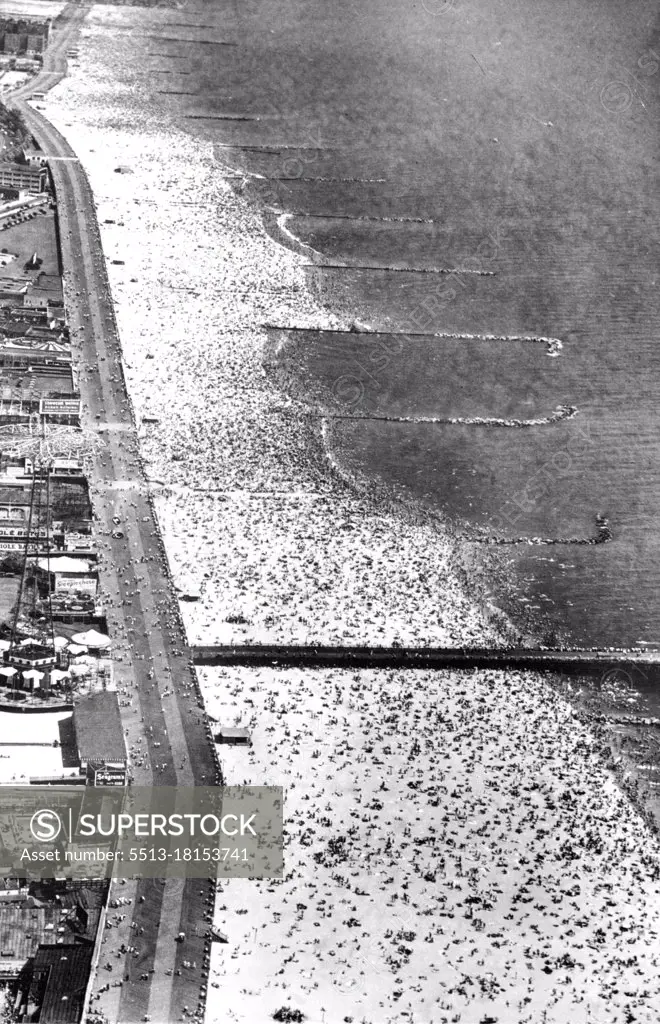 Mecca Of Melting Millions Plus -- A crowd estimated at more than one and one-half million persons by Police Capt. Walter Winterhalter, swarm on the Sandy Beach and in the surf in effort to escape fifth day of the heat wave which kept temperatures in the nineties, Aug. 29, in the New York Metropolitan Area. August 29, 1948. (Photo by Associated Press Photo).